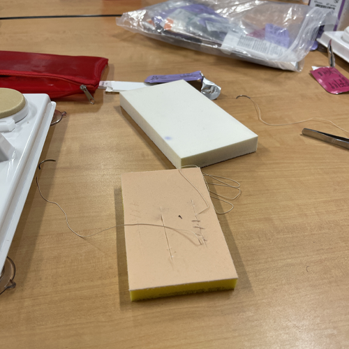 A block resembling skin is being used to learn how to suture.